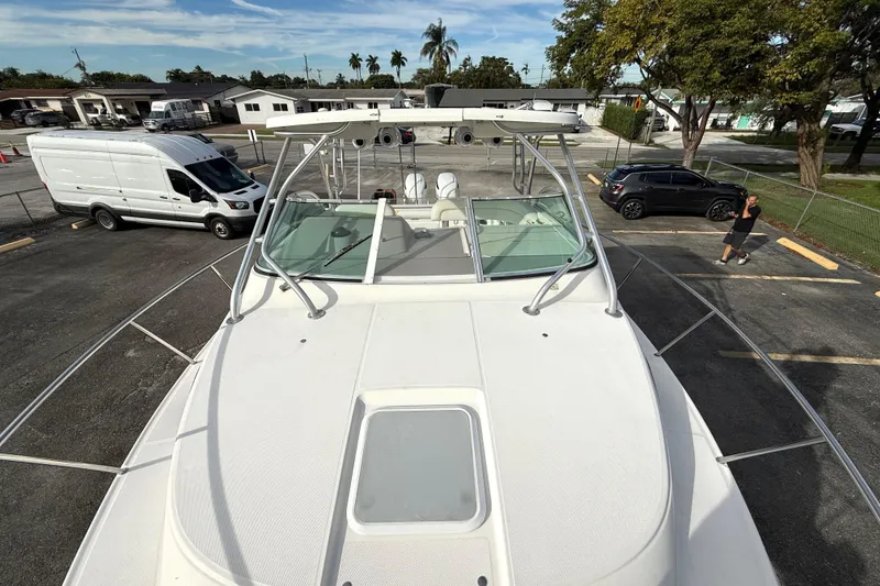 Slide: The Image of 2005 Wellcraft 290 Coastal boat parked in a lot with vehicles nearby. - 9