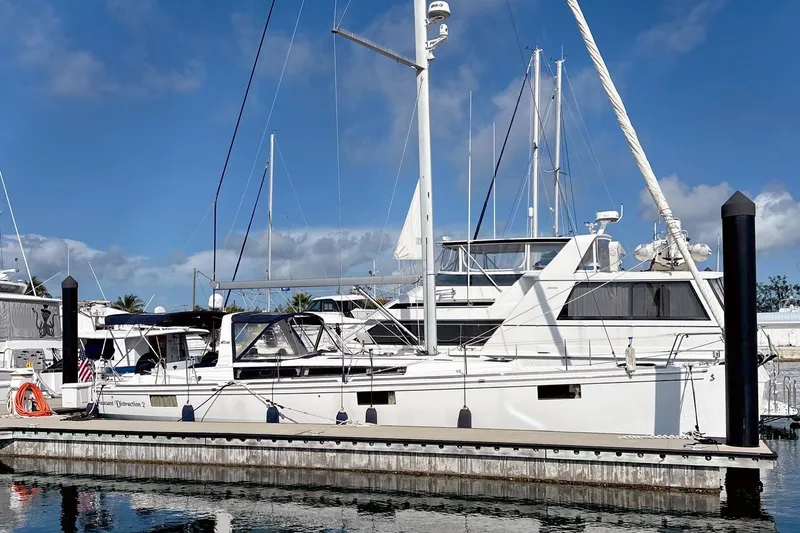 The Image of 2014 Beneteau Oceanis 48 sailboat docked at marina under clear blue sky. - 0