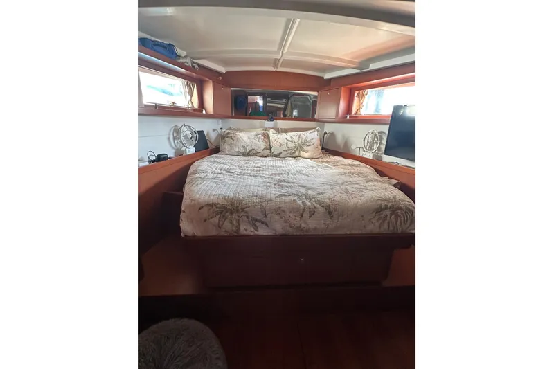 Slide: The Image of Cozy bedroom interior of 2014 Beneteau Oceanis 48 yacht with double bed and windows. - 10