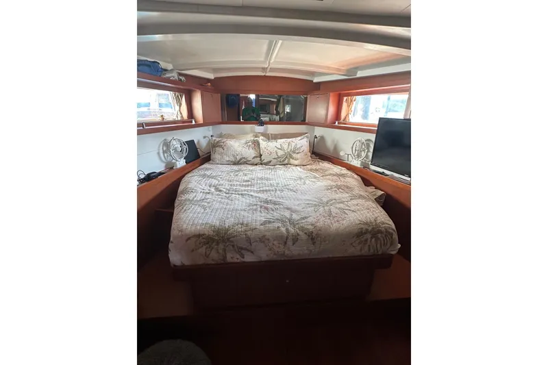 Slide: The Image of Cozy bedroom interior of 2014 Beneteau Oceanis 48 yacht with double bed and windows. - 12