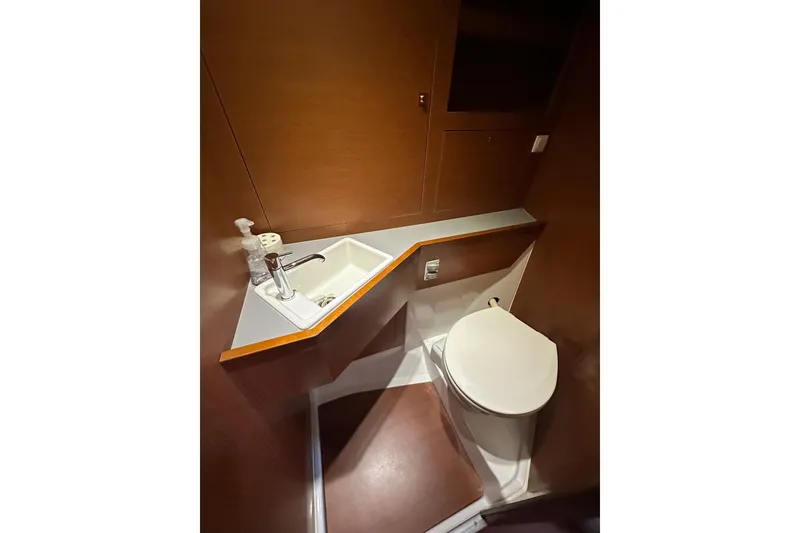 Slide: The Image of Bathroom interior of 2014 Beneteau Oceanis 48 yacht, featuring sink and toilet. - 15