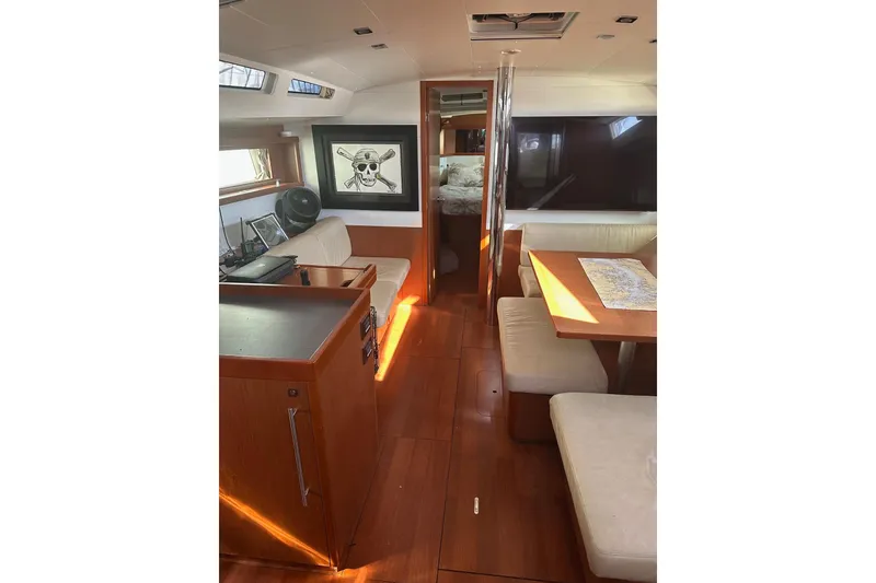 Slide: The Image of Interior of 2014 Beneteau Oceanis 48 yacht with wooden flooring and cozy seating area. - 6