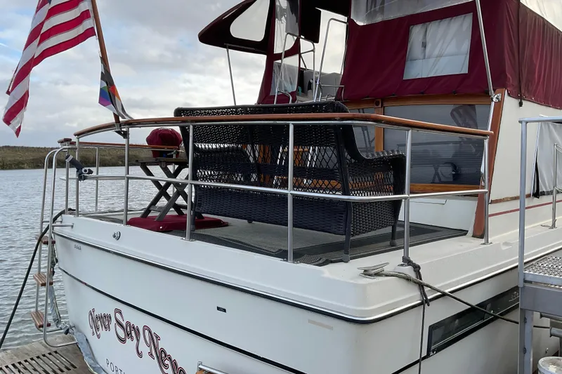 Slide: The Image of 1982 Bayliner 4050 Bodega yacht with deck seating, docked by the water. - 10