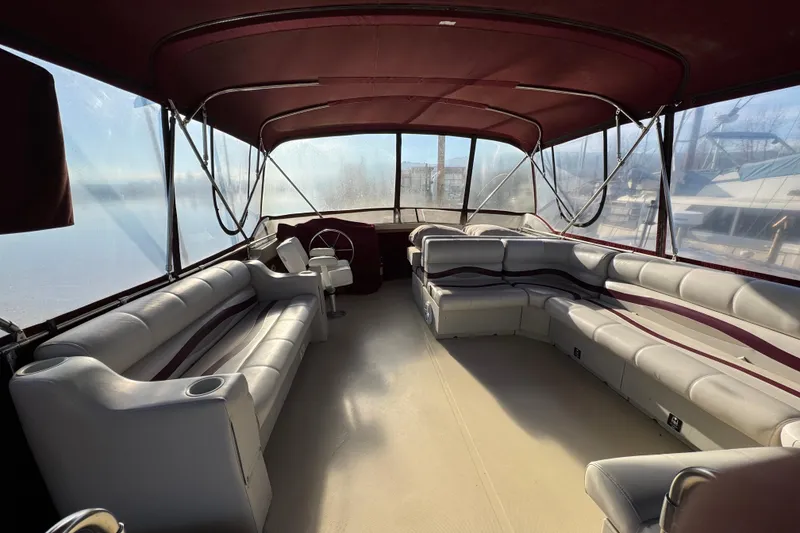 Slide: The Image of 1982 Bayliner 4050 Bodega interior with spacious seating and maroon canopy. - 11