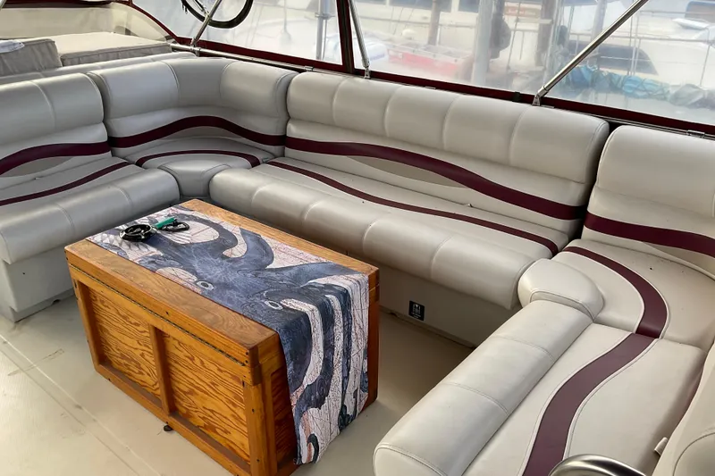 Slide: The Image of 1982 Bayliner 4050 Bodega interior with curved seating and wooden table. - 14