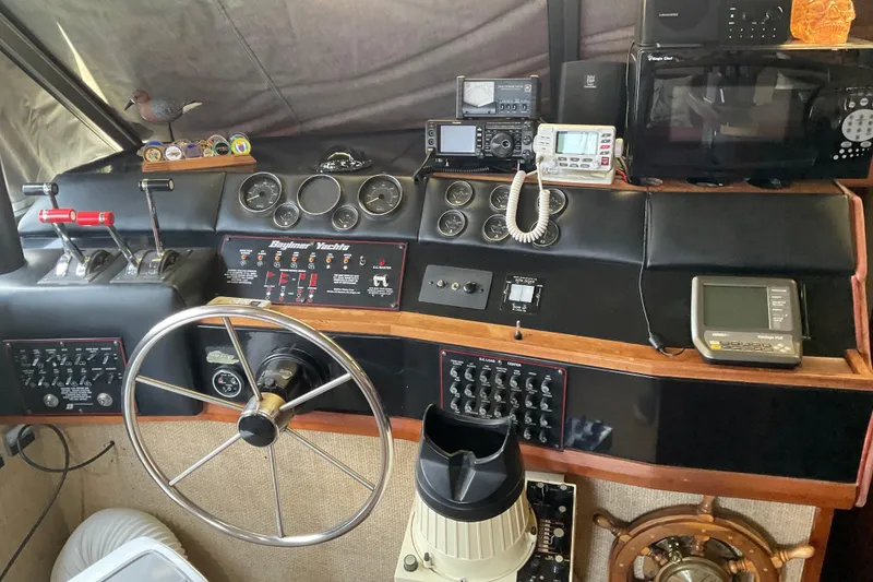 Slide: The Image of 1982 Bayliner 4050 Bodega yacht helm with navigation instruments and steering wheel. - 16