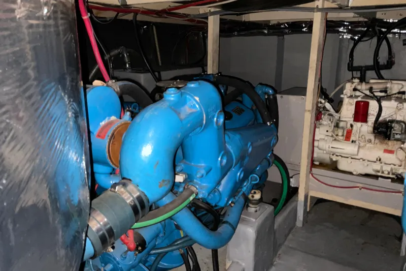 Slide: The Image of Engine room of 1982 Bayliner 4050 Bodega with blue and white machinery. - 27