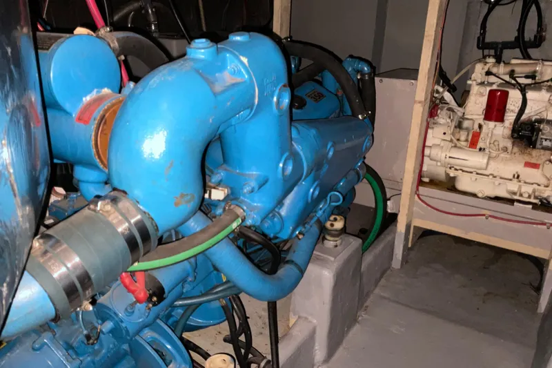 Slide: The Image of Engine room of 1982 Bayliner 4050 Bodega with blue marine engine components. - 28