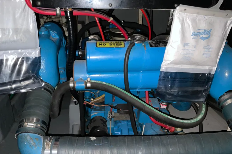 Slide: The Image of Engine compartment of 1982 Bayliner 4050 Bodega with blue engine and DampRid bags. - 30