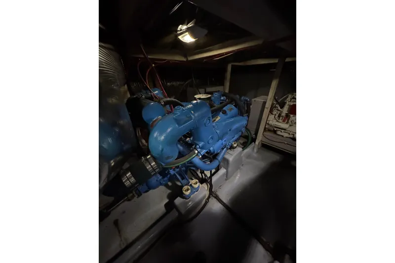Slide: The Image of Engine compartment of 1982 Bayliner 4050 Bodega, featuring a blue marine engine. - 31