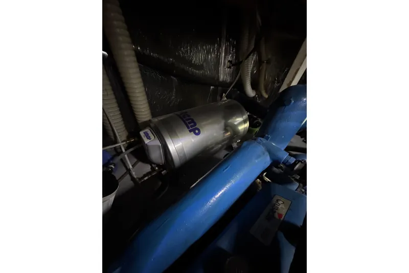 Slide: The Image of Engine room of 1982 Bayliner 4050 Bodega with visible components and piping. - 35