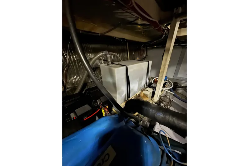 Slide: The Image of Engine room of 1982 Bayliner 4050 Bodega with visible components and wiring. - 36