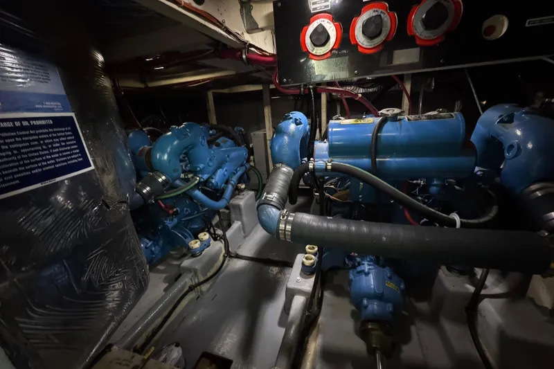 Slide: The Image of Engine room of 1982 Bayliner 4050 Bodega with blue machinery and control panel. - 37