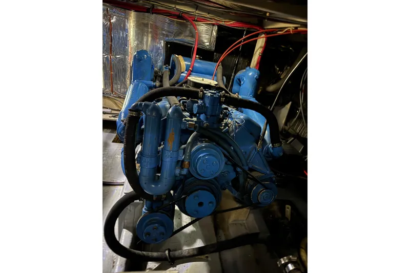 Slide: The Image of Engine of 1982 Bayliner 4050 Bodega boat, featuring blue components and visible wiring. - 38