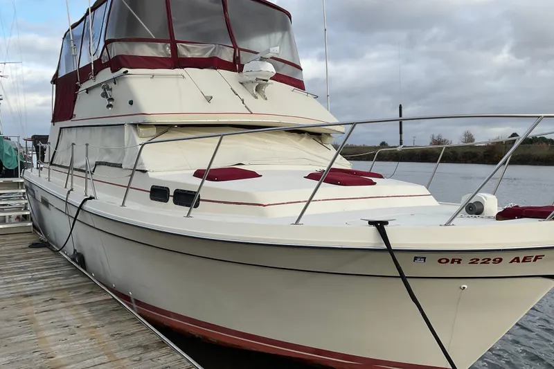 Slide: The Image of 1982 Bayliner 4050 Bodega docked, featuring maroon accents and spacious deck. - 4