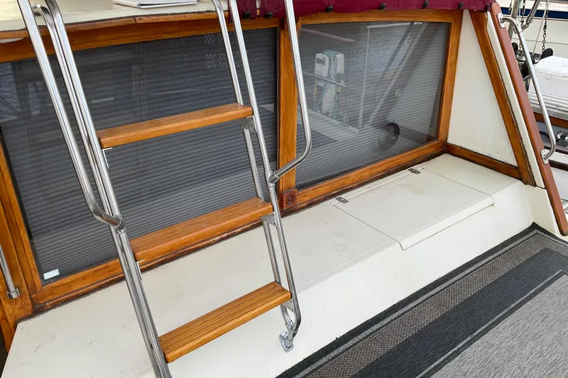 Slide: The Image of 1982 Bayliner 4050 Bodega boat with wooden ladder and window detail. - 5