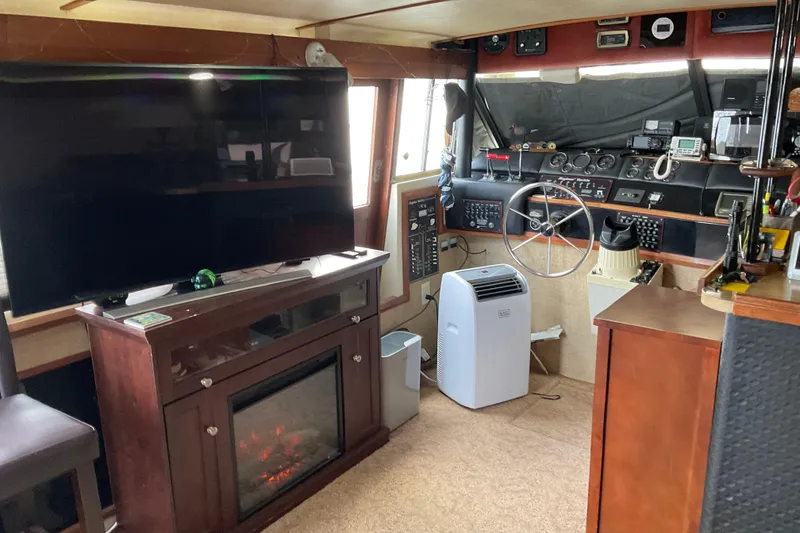 Slide: The Image of Interior of 1982 Bayliner 4050 Bodega with helm, TV, and fireplace. - 7