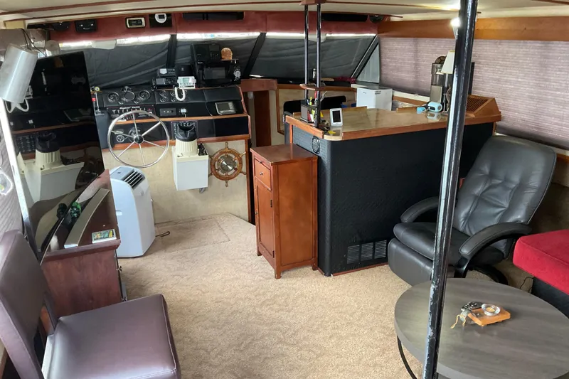 Slide: The Image of Interior of a 1982 Bayliner 4050 Bodega yacht with helm, seating, and navigation equipment. - 8