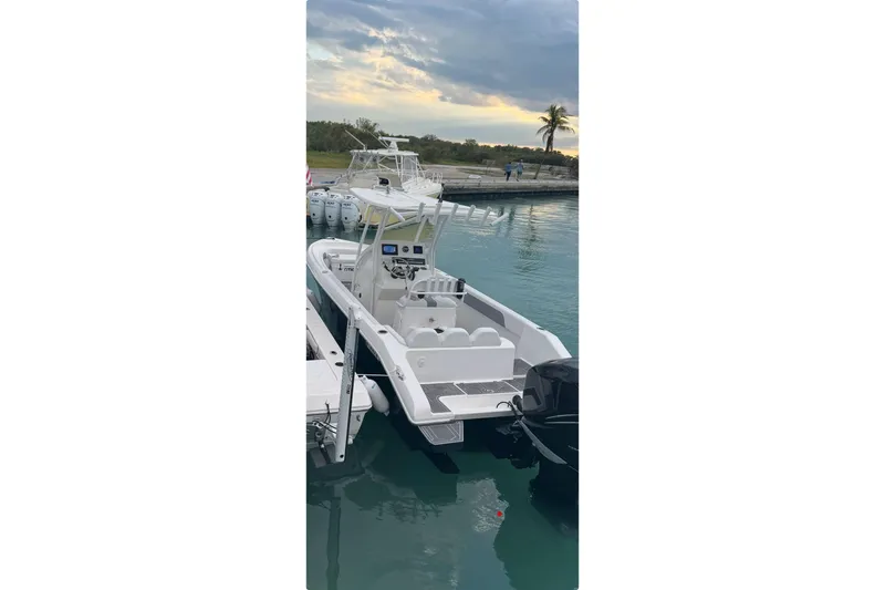 Slide: The Image of 2018 Carrera Powerboats 23 docked in serene waters at sunset. - 10
