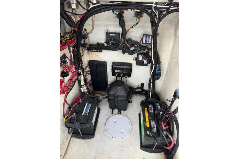 Slide: The Image of 2018 Carrera Powerboats 23 engine compartment with batteries and wiring. - 11