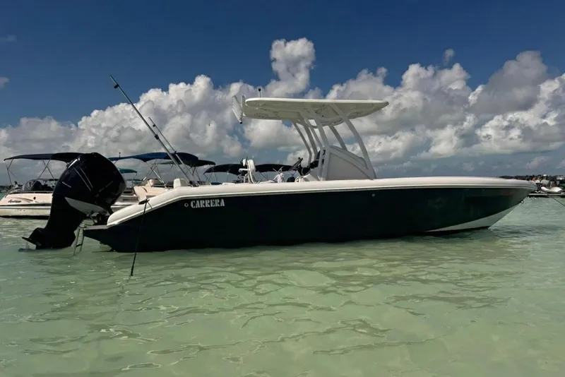 Slide: The Image of 2018 Carrera Powerboats 23 in shallow water, under a clear blue sky. - 14