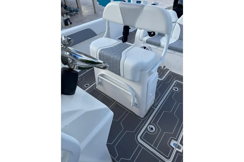 Slide: The Image of 2018 Carrera Powerboats 23 interior with white seating and modern flooring design. - 3