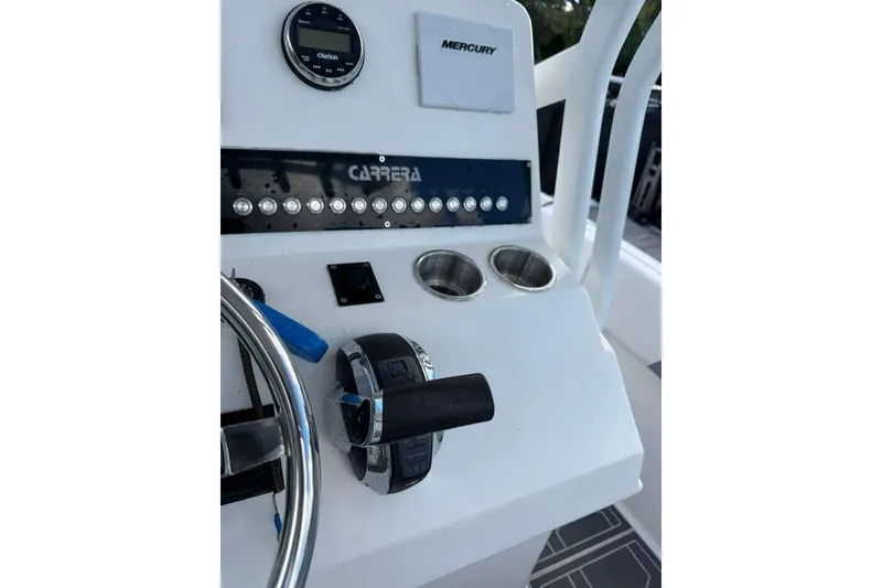 Slide: The Image of Control panel of 2018 Carrera Powerboats 23, featuring steering wheel and throttle. - 8