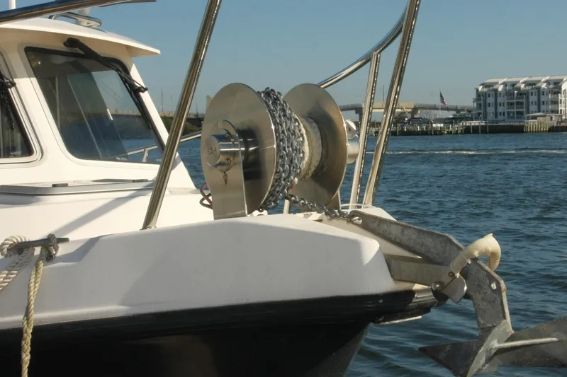 Slide: The Image of 2017 Osprey 30 Fisherman boat with anchor and winch on calm water. - 2