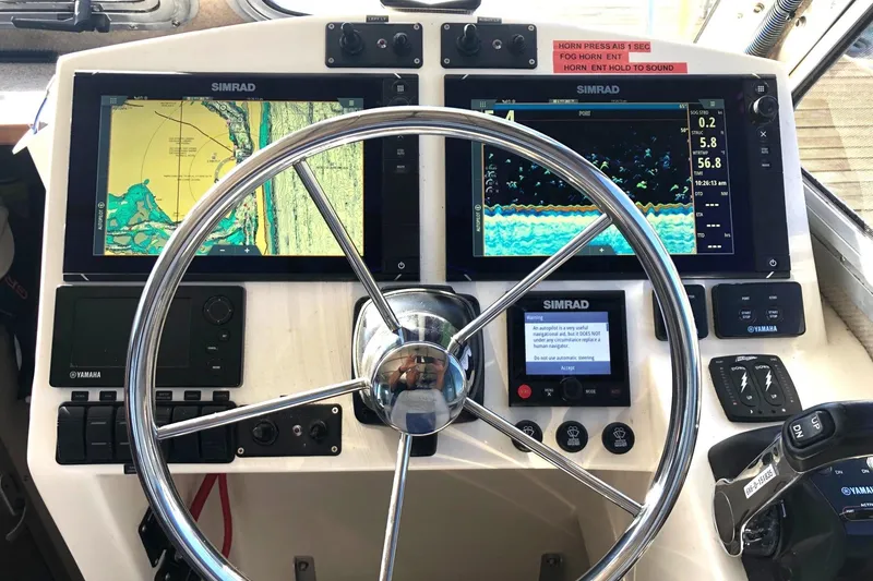 Slide: The Image of Control panel of a 2017 Osprey 30 Fisherman boat with Simrad navigation displays. - 3