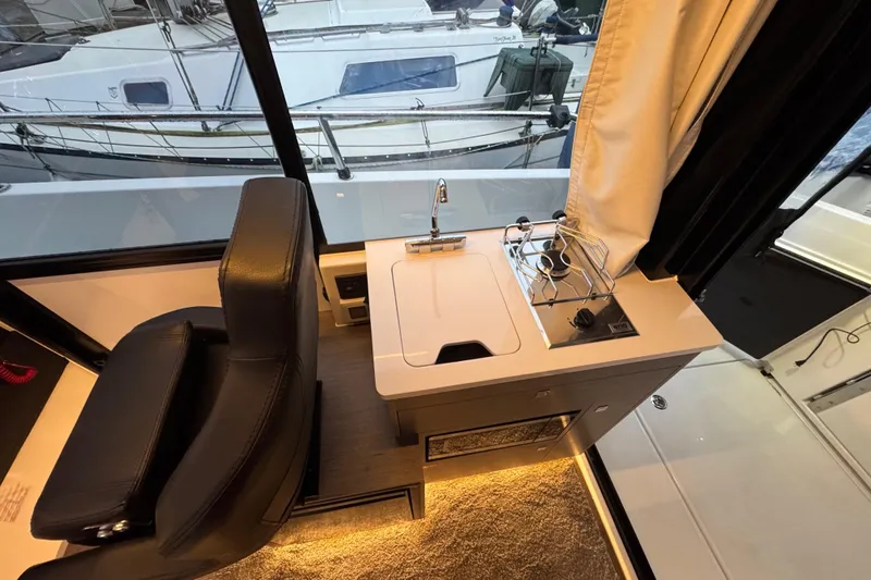 Slide: The Image of Interior of 2025 Jeanneau NC 895 Sport Series 2 with compact kitchen area. - 10