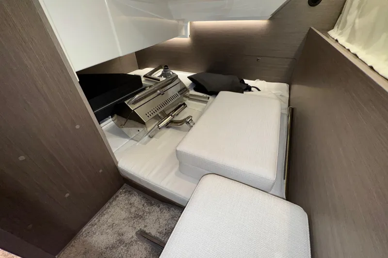 Slide: The Image of Interior cabin of 2025 Jeanneau NC 895 Sport Series 2, featuring modern design and compact layout. - 12