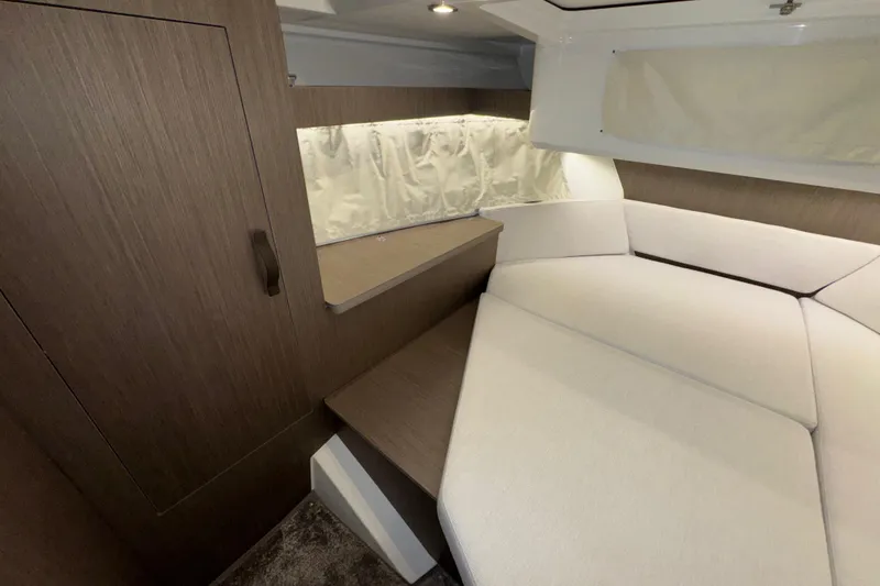 Slide: The Image of Interior cabin of 2025 Jeanneau NC 895 Sport Series 2, featuring modern wood finish and cozy seating. - 14
