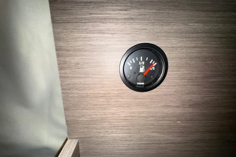 Slide: The Image of Fuel gauge on Jeanneau NC 895 Sport Series 2, 2025 model, wooden panel background. - 16