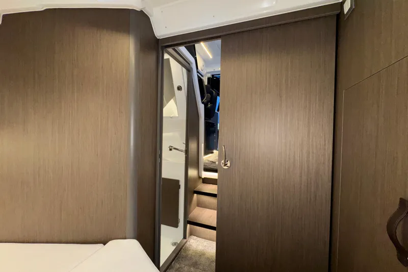 Slide: The Image of Interior of 2025 Jeanneau NC 895 Sport Series 2, featuring modern wood paneling and sleek design. - 18