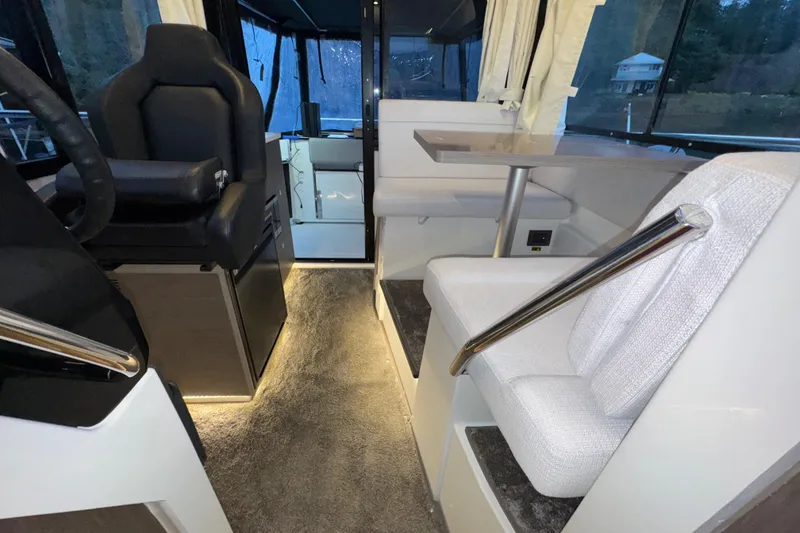Slide: The Image of Interior of 2025 Jeanneau NC 895 Sport Series 2, featuring modern seating and helm area. - 20