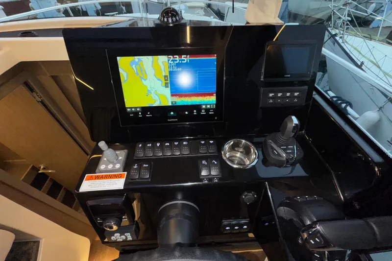 Slide: The Image of Control panel of 2025 Jeanneau NC 895 Sport Series 2 with navigation display and controls. - 25
