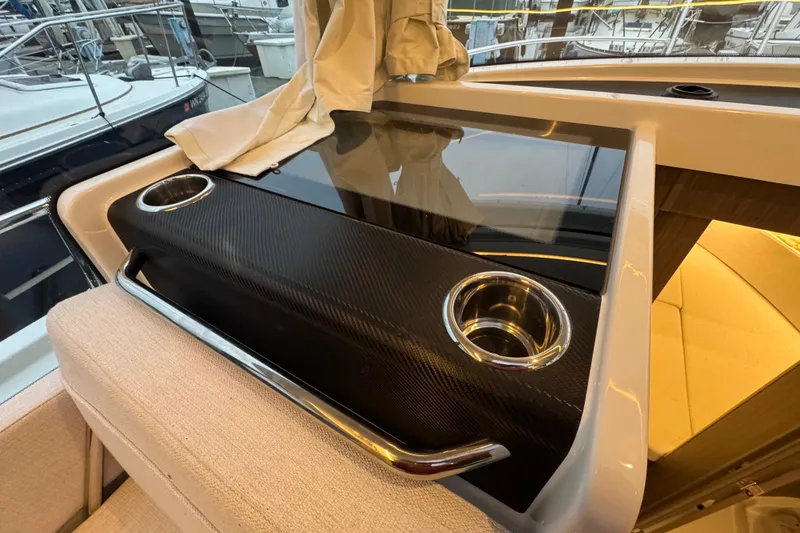Slide: The Image of 2025 Jeanneau NC 895 Sport Series 2 interior with cup holders and sleek design. - 30