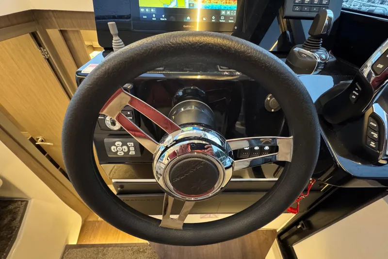Slide: The Image of Steering wheel of 2025 Jeanneau NC 895 Sport Series 2 boat cockpit. - 31