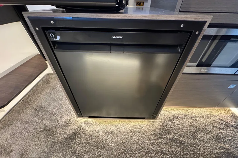 Slide: The Image of Compact kitchen area in the 2025 Jeanneau NC 895 Sport Series 2 boat. - 33