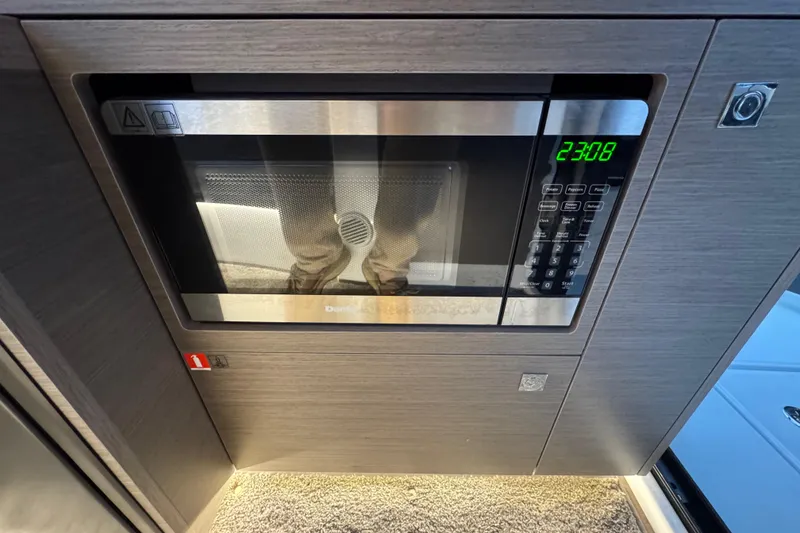 Slide: The Image of Microwave in 2025 Jeanneau NC 895 Sport Series 2 boat interior. - 34