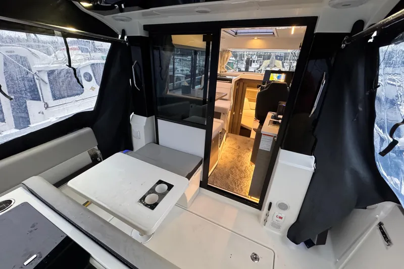 Slide: The Image of Interior view of 2025 Jeanneau NC 895 Sport Series 2 boat, featuring seating and table. - 35