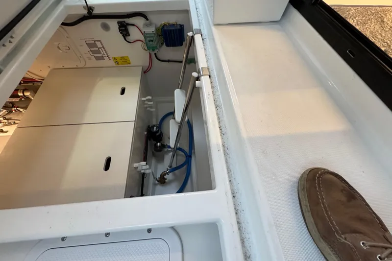 Slide: The Image of Interior view of 2025 Jeanneau NC 895 Sport Series 2 boat, showcasing storage compartment and wiring. - 45