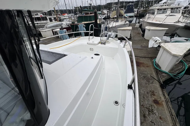 Slide: The Image of 2025 Jeanneau NC 895 Sport Series 2 docked at a marina, showcasing sleek design. - 53