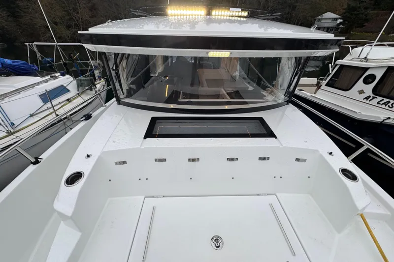 Slide: The Image of 2025 Jeanneau NC 895 Sport Series 2 boat docked, featuring sleek design and spacious deck. - 60