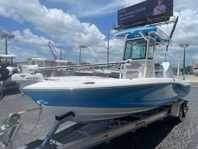 Slide: The Image of 2023 Caymas 26 HB boat on trailer, blue hull, sunny day. - 1