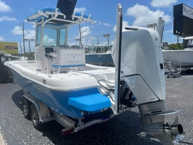 Slide: The Image of 2023 Caymas 26 HB boat on trailer, blue sky. - 2