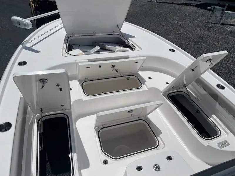Slide: The Image of 2023 Caymas 26 HB boat with open storage compartments. - 4
