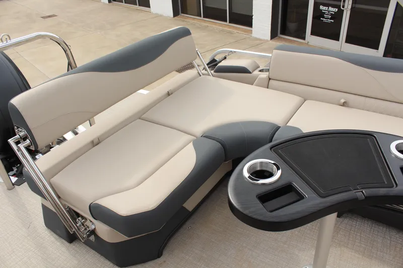 Slide: The Image of 2026 Tahoe Pontoon LTZ interior with beige and gray seating, featuring a sleek black table. - 11