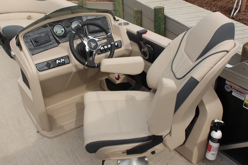 Slide: The Image of 2026 Tahoe Pontoon LTZ helm with beige captain's chair and modern dashboard controls. - 13