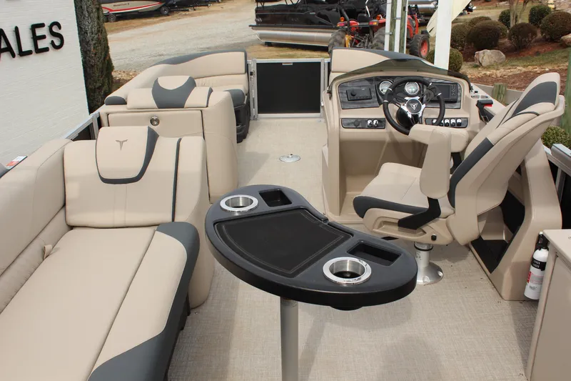 Slide: The Image of 2026 Tahoe Pontoon LTZ interior with beige seating and modern helm. - 15